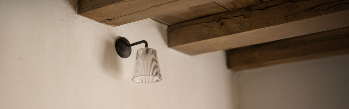 Bronze pendant wall light with fluted glass by Corston bedside
