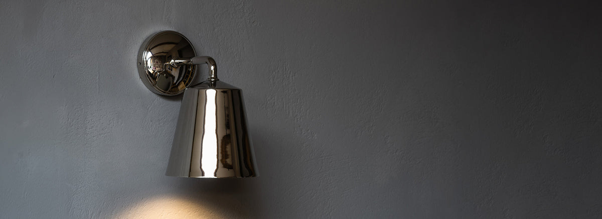 Polished Nickel bedroom wall light on grey wall